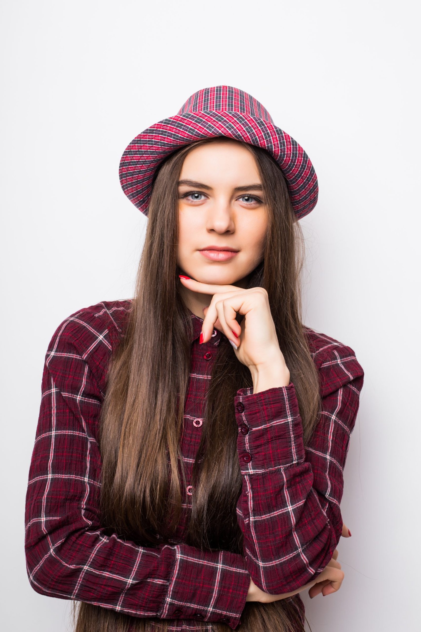 Causal female in curly hair posing with arms crossed